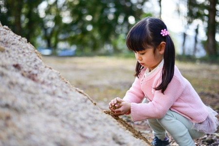 幼女が一人で砂遊びする様子